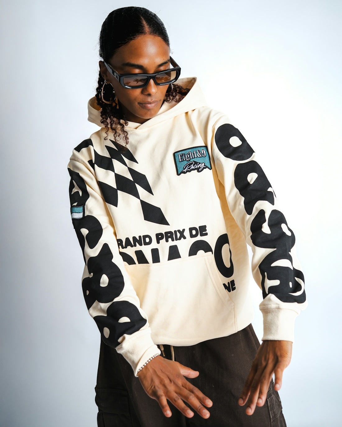 Cream hoodie with racing graphics and text.