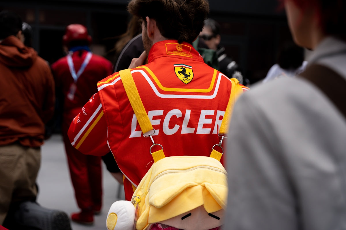 Red ferrari racing suit with 'lecler' on the back.